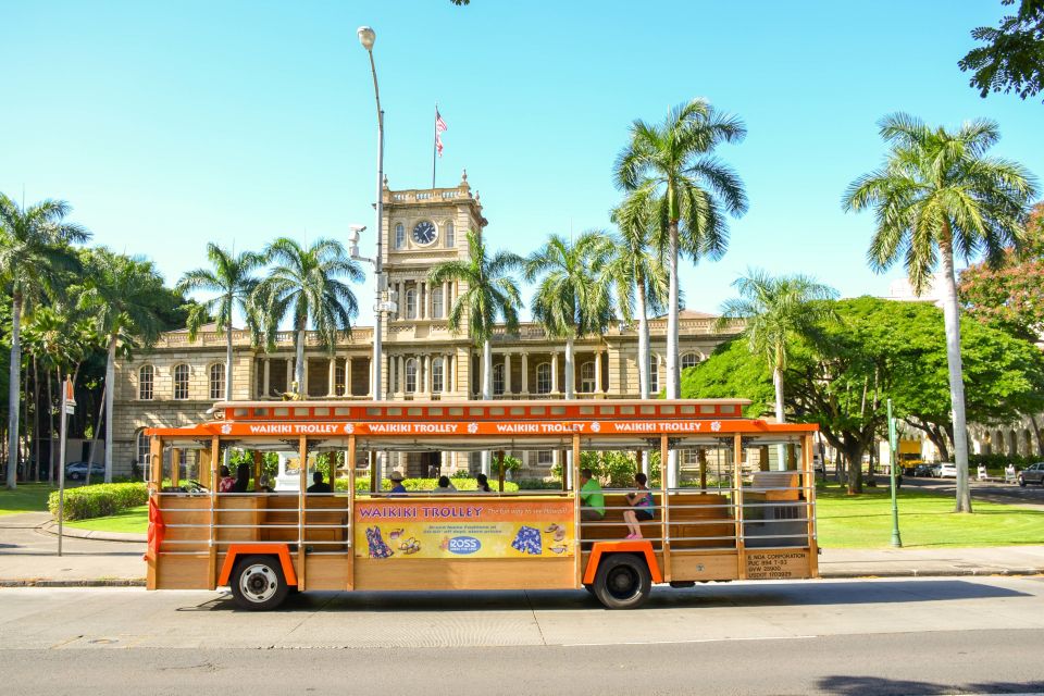 Oahu- Waikiki Trolley in front of gov building and statue in oahue