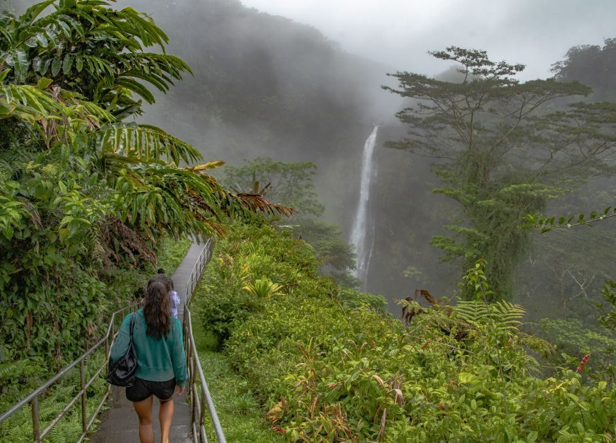 Hawaiian islands online., Hawaii News, people on small bridge going towards waterfall