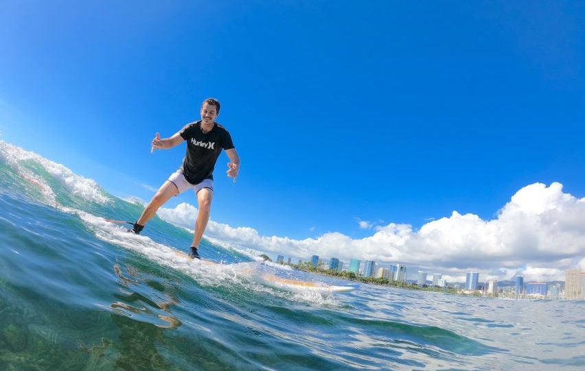 Oahu- Group Surfing Lesson in Waikiki Beach surfer riding wave